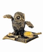 Owl on a book with a magnifying glass